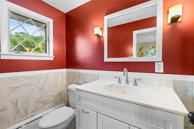 5 Hingham Rd, Utica, NY 13501 - bathroom featuring vanity, tile walls, a baseboard heating unit, and wainscoting