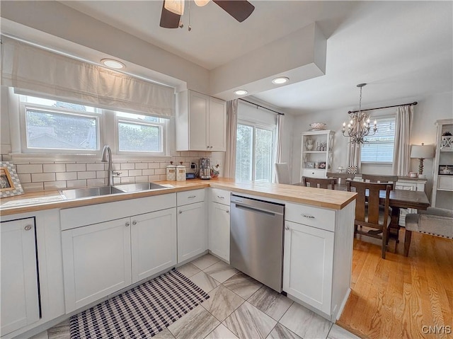8 Harnden St, Auburn, NY 13021 - kitchen with dishwasher, butcher block counters, plenty of natural light, a peninsula, and recessed lighting