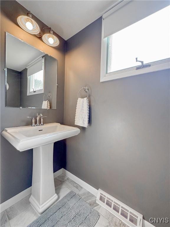 8 Harnden St, Auburn, NY 13021 - bathroom featuring marble look tile flooring and baseboards