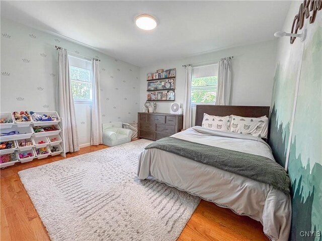 8 Harnden St, Auburn, NY 13021 - bedroom featuring multiple windows and wood finished floors