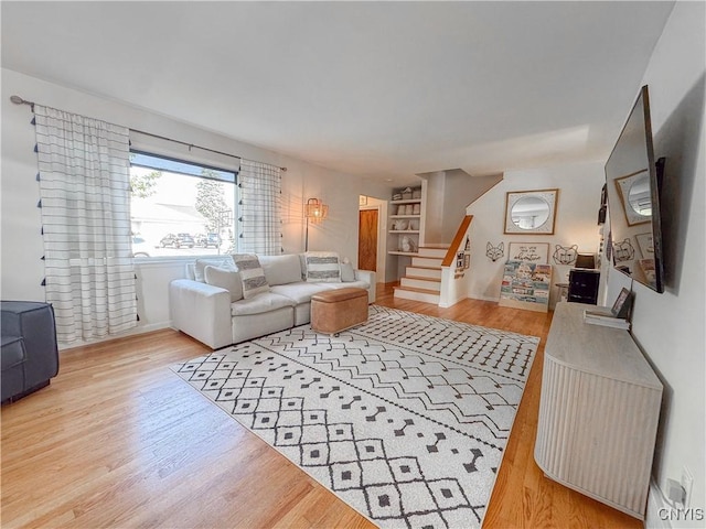 8 Harnden St, Auburn, NY 13021 - living area featuring wood finished floors and stairway