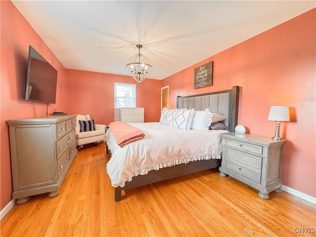 8 Harnden St, Auburn, NY 13021 - bedroom with light wood-style floors and a chandelier