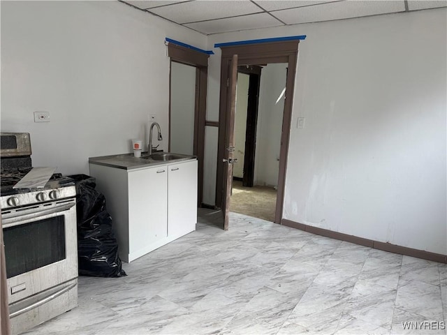 99 Sattler Ave, Buffalo, NY 14211 - kitchen featuring stainless steel gas stove, white cabinetry, a drop ceiling, and light marble finish floors