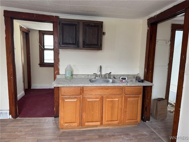 99 Sattler Ave, Buffalo, NY 14211 - kitchen featuring light countertops, ornamental molding, brown cabinets, and light wood-style flooring
