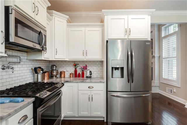 405 Greystone Dr, Horseheads, NY 14845 - kitchen with appliances with stainless steel finishes, white cabinets, crown molding, dark wood-style floors, and backsplash