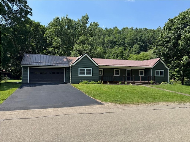 6365 Honey Run Rd, Hornellsville, NY 14843 - ranch-style home featuring asphalt driveway, a garage, a front lawn, and a metal roof