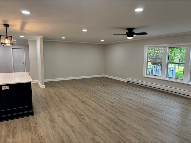 6365 Honey Run Rd, Hornellsville, NY 14843 - unfurnished living room featuring a baseboard radiator, crown molding, recessed lighting, wood finished floors, and ceiling fan