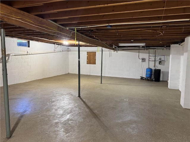 6365 Honey Run Rd, Hornellsville, NY 14843 - unfinished basement featuring a water pressure tank and concrete block wall