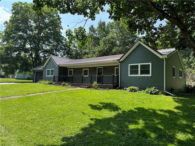 6365 Honey Run Rd, Hornellsville, NY 14843 - ranch-style house with a porch, a front lawn, a garage, and a metal roof