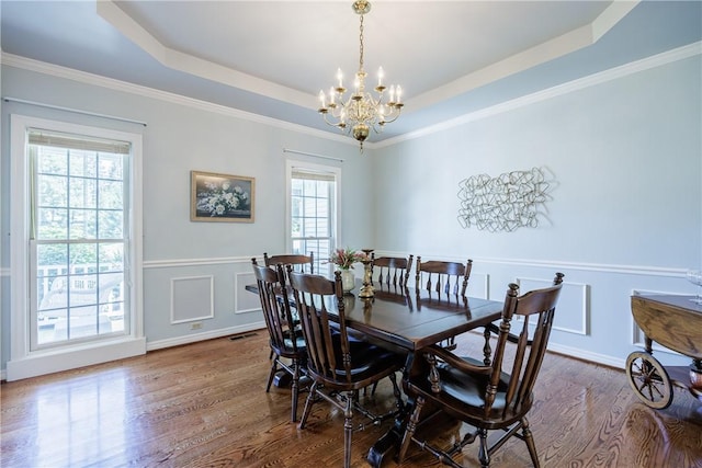117 Neuchatel Ln, Perinton, NY 14450 - dining space featuring a chandelier, dark wood-type flooring, a raised ceiling, and crown molding