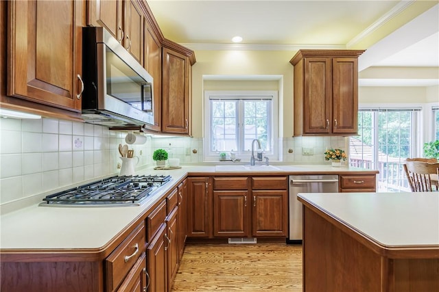 117 Neuchatel Ln, Perinton, NY 14450 - kitchen with appliances with stainless steel finishes, healthy amount of natural light, light countertops, light wood-style floors, and crown molding