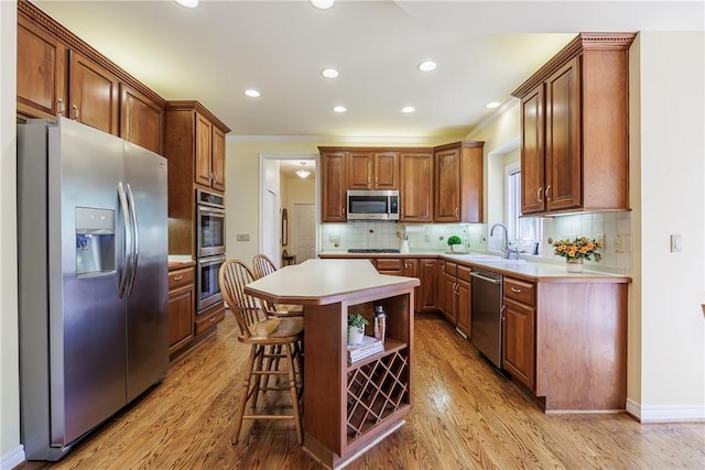 117 Neuchatel Ln, Perinton, NY 14450 - kitchen featuring appliances with stainless steel finishes, light wood-style flooring, light countertops, crown molding, and decorative backsplash
