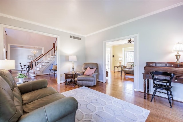 117 Neuchatel Ln, Perinton, NY 14450 - living room with ornamental molding, wood finished floors, a chandelier, and stairway