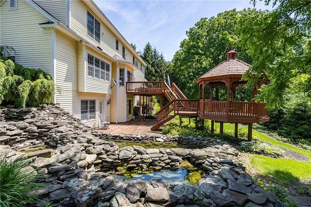 117 Neuchatel Ln, Perinton, NY 14450 - view of playground with stairs, a deck, a gazebo, and a garden pond