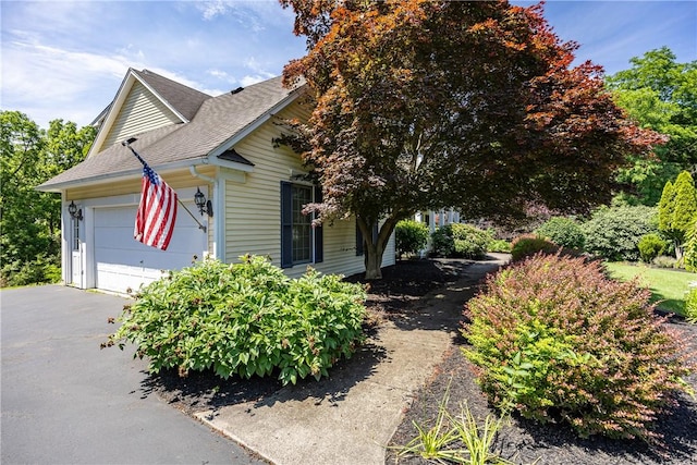 117 Neuchatel Ln, Perinton, NY 14450 - view of front facade with an attached garage, roof with shingles, and driveway
