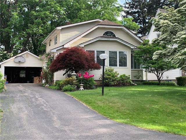125 Sunset Dr, Brighton, NY 14618 - view of front facade featuring an outdoor structure, a detached garage, a front yard, and a chimney