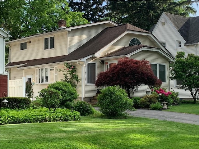 125 Sunset Dr, Brighton, NY 14618 - view of front of home with a front yard and a chimney