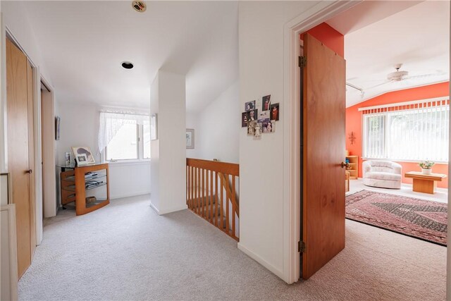 125 Sunset Dr, Brighton, NY 14618 - corridor featuring light colored carpet, vaulted ceiling, and an upstairs landing