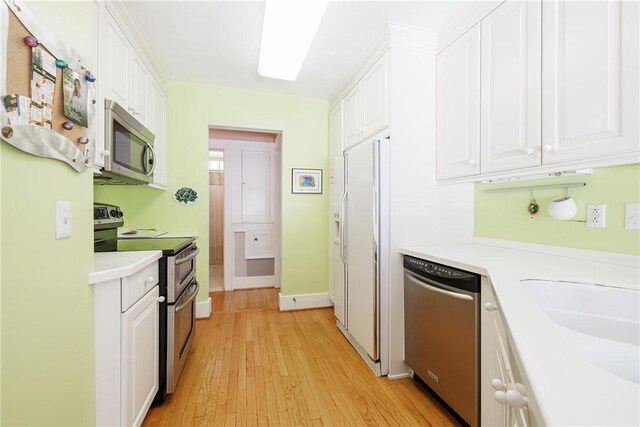 125 Sunset Dr, Brighton, NY 14618 - kitchen featuring appliances with stainless steel finishes, white cabinetry, light countertops, and light wood-style floors