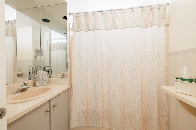 125 Sunset Dr, Brighton, NY 14618 - bathroom featuring vanity, curtained shower, and wainscoting
