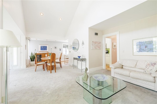 125 Sunset Dr, Brighton, NY 14618 - living room featuring light colored carpet, high vaulted ceiling, healthy amount of natural light, and recessed lighting