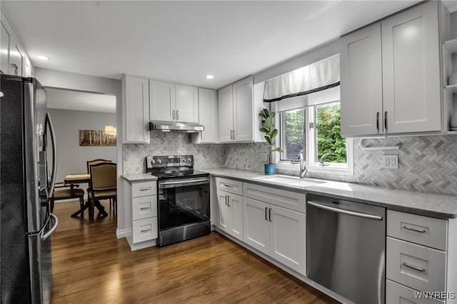 160 Greengage Cir, Amherst, NY 14051 - kitchen featuring stainless steel appliances, under cabinet range hood, dark wood-type flooring, tasteful backsplash, and recessed lighting