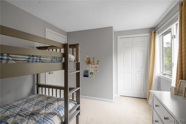 160 Greengage Cir, Amherst, NY 14051 - bedroom featuring light carpet, a closet, and a textured ceiling