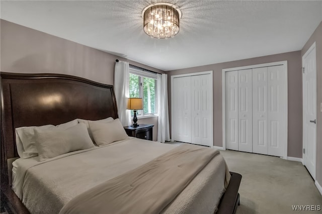160 Greengage Cir, Amherst, NY 14051 - carpeted bedroom featuring multiple closets and a chandelier
