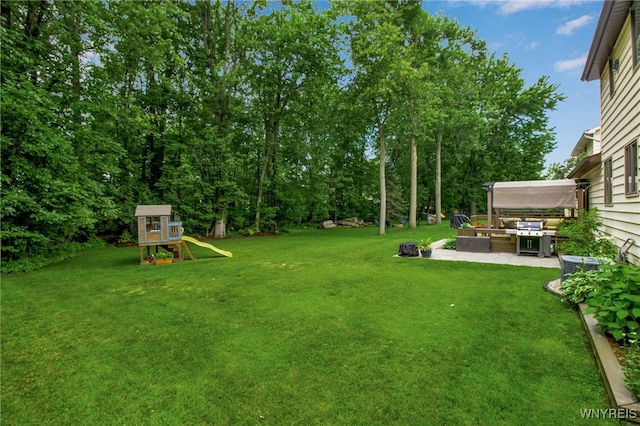 160 Greengage Cir, Amherst, NY 14051 - view of grassy yard featuring a patio and a playground