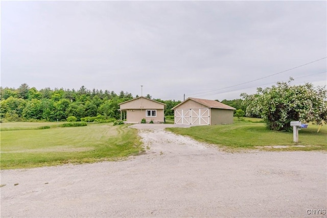 218 Campbell Rd, Gouverneur, NY 13642 - view of front of property with a front lawn, an outbuilding, a barn, driveway, and a garage