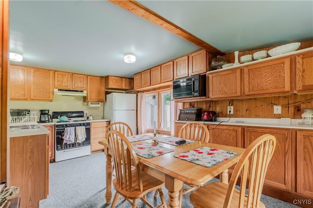 218 Campbell Rd, Gouverneur, NY 13642 - kitchen with white appliances, under cabinet range hood, light countertops, light carpet, and brown cabinets