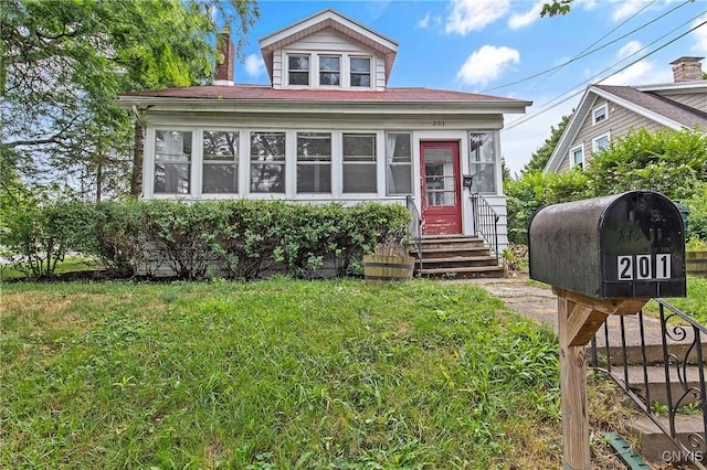 201 Mosley Dr, Syracuse, NY 13206 - view of front of property featuring a sunroom and a front lawn
