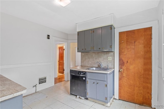 201 Mosley Dr, Syracuse, NY 13206 - kitchen featuring black dishwasher, gray cabinetry, decorative backsplash, and light countertops