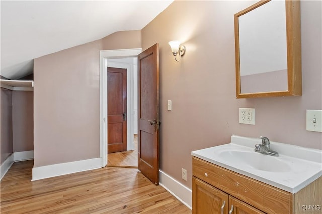 201 Mosley Dr, Syracuse, NY 13206 - bathroom with wood finished floors, vanity, and vaulted ceiling
