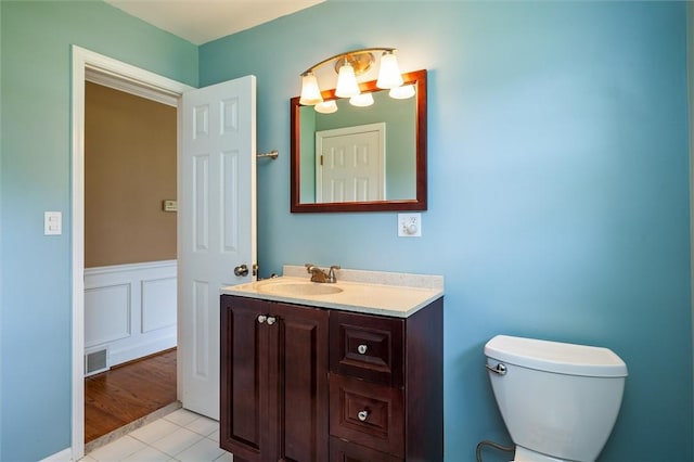 179 Down St, Henrietta, NY 14623 - half bathroom with vanity, tile patterned flooring, and wainscoting