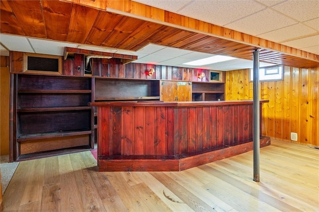 179 Down St, Henrietta, NY 14623 - below grade area with wood finished floors, wood walls, and bar