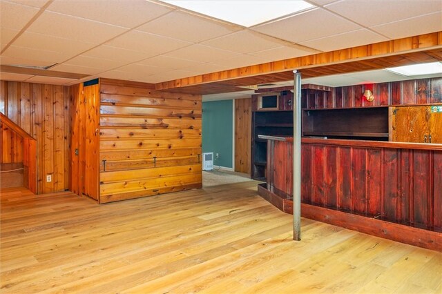 179 Down St, Henrietta, NY 14623 - finished below grade area with a drop ceiling, wood finished floors, wooden walls, bar area, and stairway