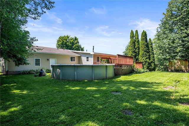 179 Down St, Henrietta, NY 14623 - view of green lawn with an outdoor pool and a deck