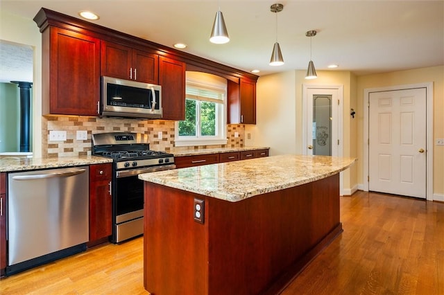 179 Down St, Henrietta, NY 14623 - kitchen featuring stainless steel appliances, dark brown cabinets, light wood-style flooring, tasteful backsplash, and decorative light fixtures