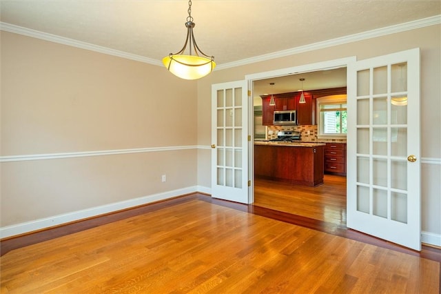 179 Down St, Henrietta, NY 14623 - unfurnished dining area featuring french doors, wood finished floors, and ornamental molding