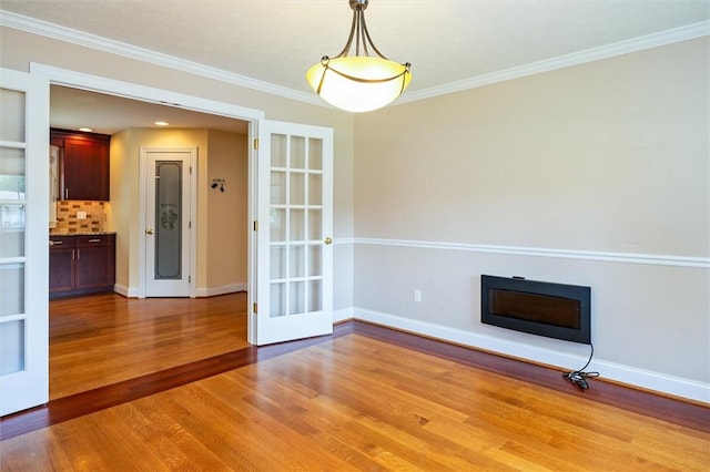 179 Down St, Henrietta, NY 14623 - unfurnished living room with light wood-type flooring, ornamental molding, and a glass covered fireplace