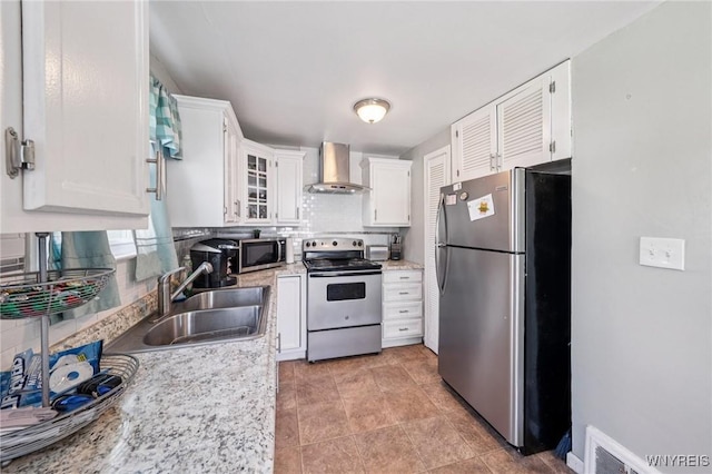 167 Somerville Ave, Tonawanda, NY 14150 - kitchen with stainless steel appliances, wall chimney exhaust hood, tasteful backsplash, white cabinetry, and glass insert cabinets