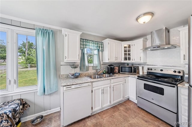 167 Somerville Ave, Tonawanda, NY 14150 - kitchen with stainless steel appliances, wall chimney exhaust hood, healthy amount of natural light, and tasteful backsplash