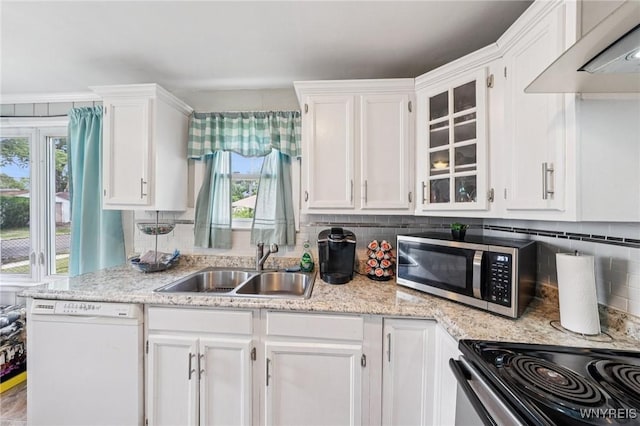 167 Somerville Ave, Tonawanda, NY 14150 - kitchen with dishwasher, stainless steel microwave, wall chimney exhaust hood, white cabinets, and backsplash
