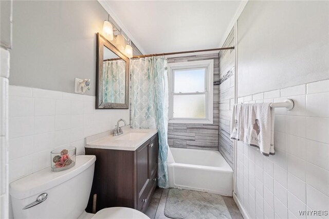 167 Somerville Ave, Tonawanda, NY 14150 - full bathroom with tile walls, vanity, and shower / bath combo with shower curtain