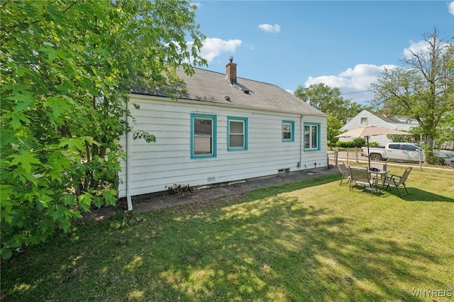 167 Somerville Ave, Tonawanda, NY 14150 - back of property featuring a chimney and a lawn