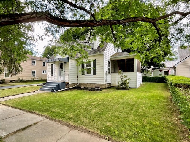 2 Washington St, North Dansville, NY 14437 - view of front of home featuring a front lawn, a sunroom, and roof with shingles