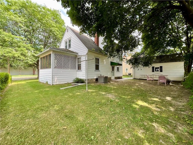 2 Washington St, North Dansville, NY 14437 - rear view of property featuring a yard and a sunroom