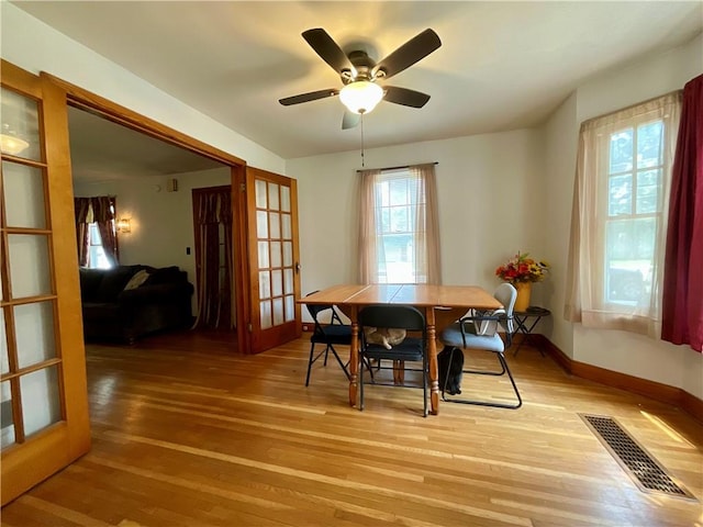 2 Washington St, North Dansville, NY 14437 - dining room with light wood-style flooring, french doors, and ceiling fan