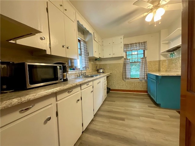 2 Washington St, North Dansville, NY 14437 - kitchen featuring stainless steel microwave, open shelves, white cabinets, and a ceiling fan